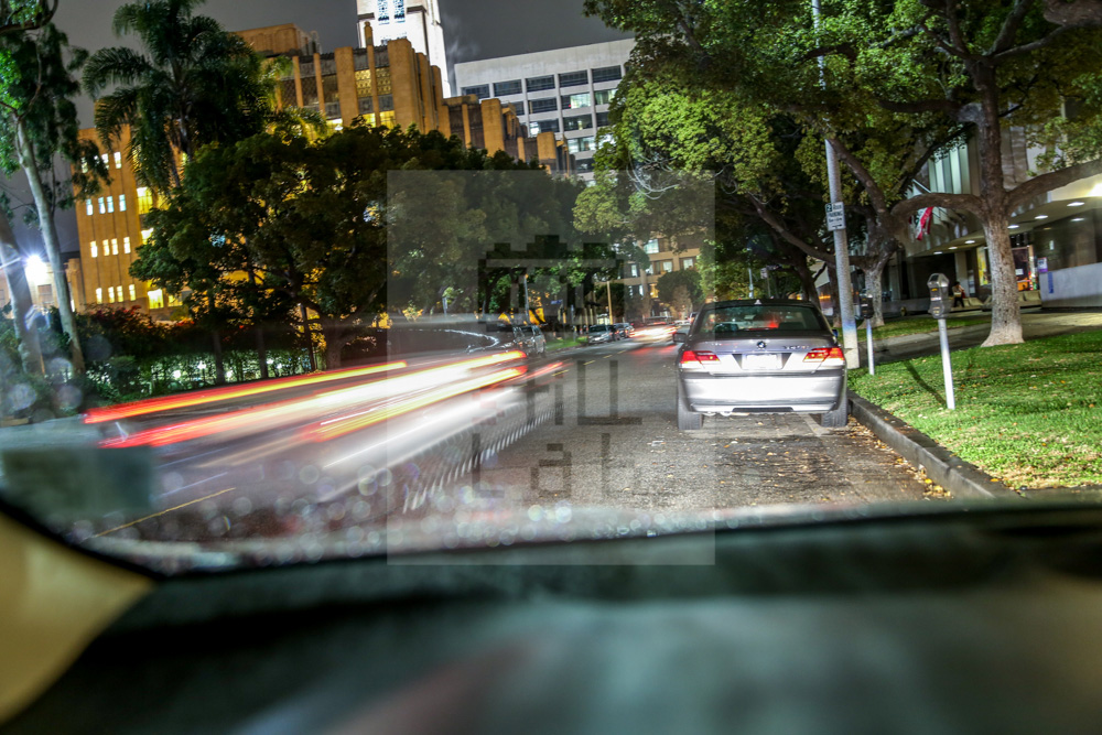 View from street parked car at night
