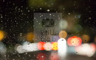 Raindrops on window reflecting city light