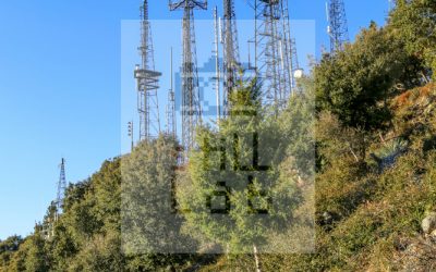 Girl walking beside tall antennas
