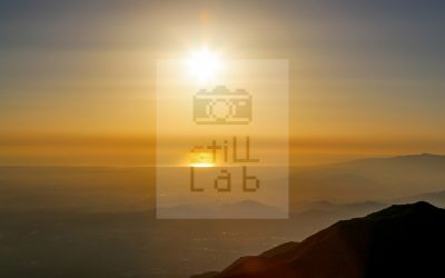 Orange sunset with mountain and city